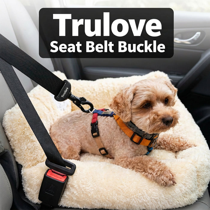 A small tan dog lying on a cream pet bed inside a car, wearing a harness attached to a black Trulove seat belt buckle. A black text banner at the top reads 'Trulove Seat Belt Buckle'. please make this photo fit in a square shape